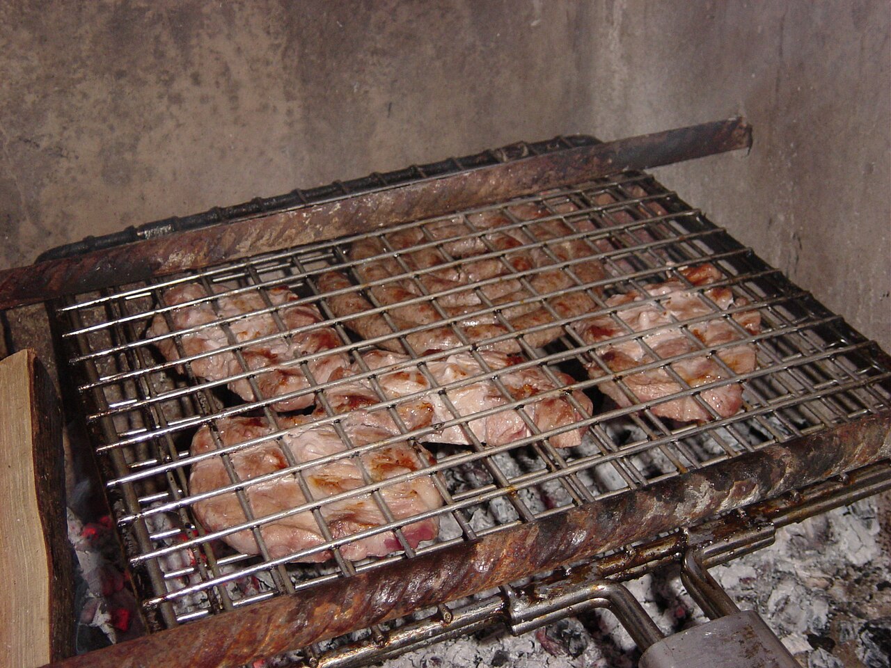 Boerewors cooking on a charcoal braai