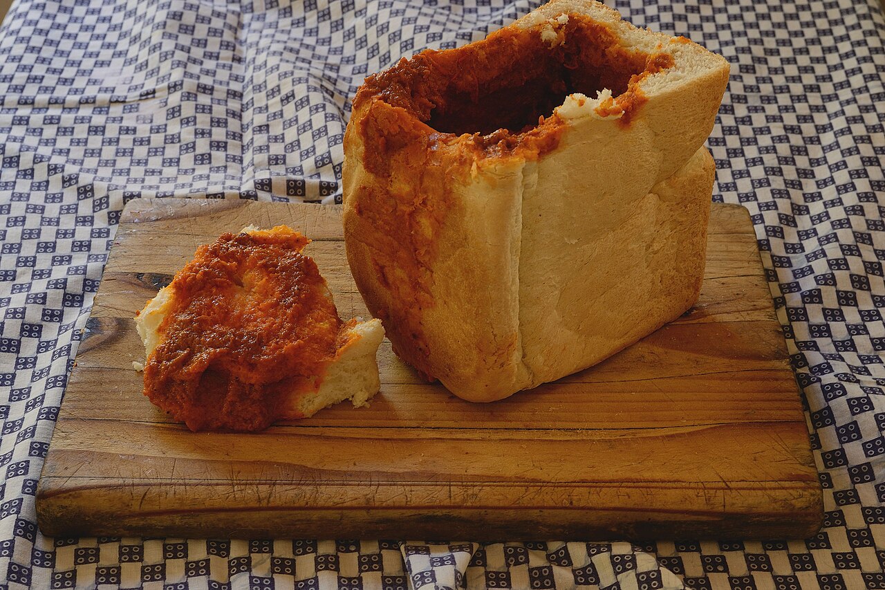 Chicken curry bunny chow in a hollowed bread portion