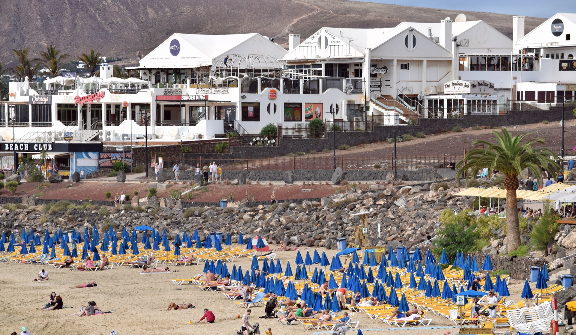 Sunbeds and the seafront behind Playa Dorada in Playa Blanca, Lanzarote