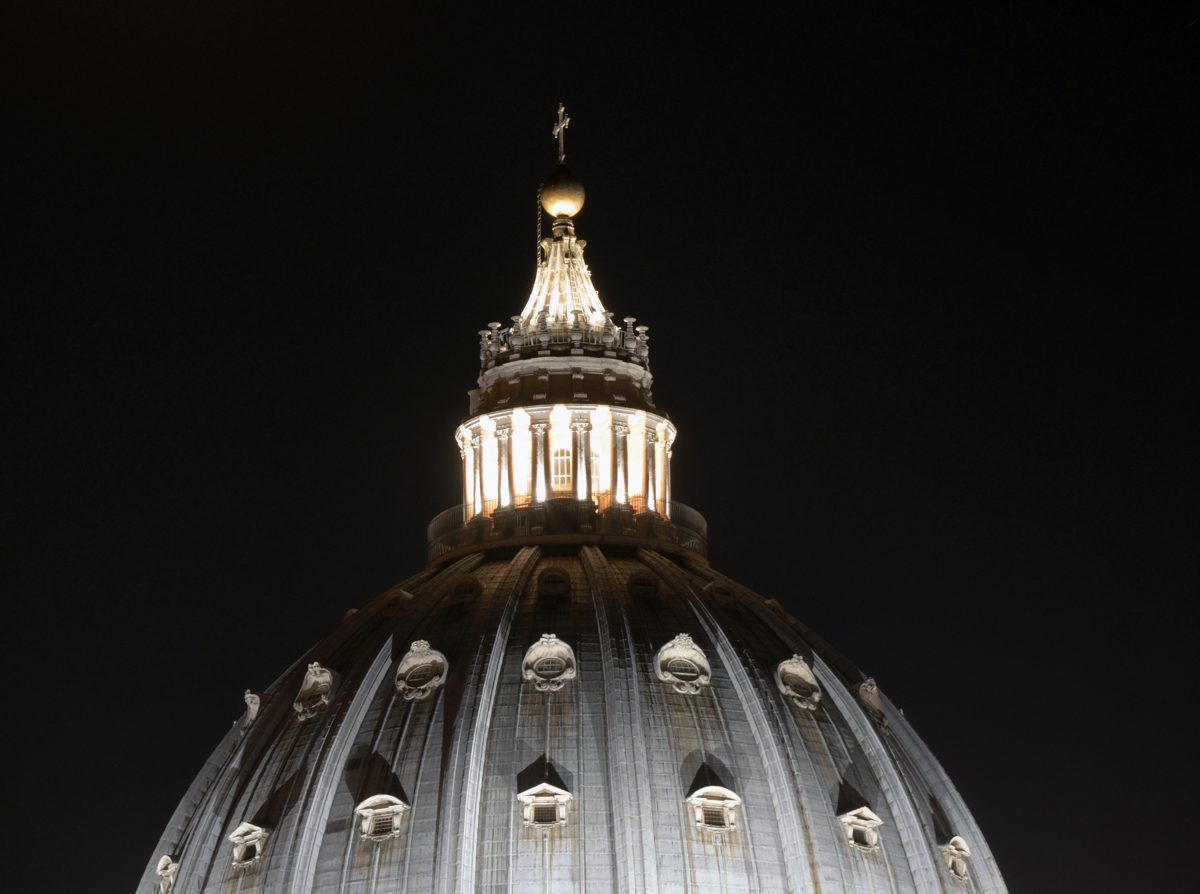 Illuminated dome and lantern of St. Peter’s Basilica at night