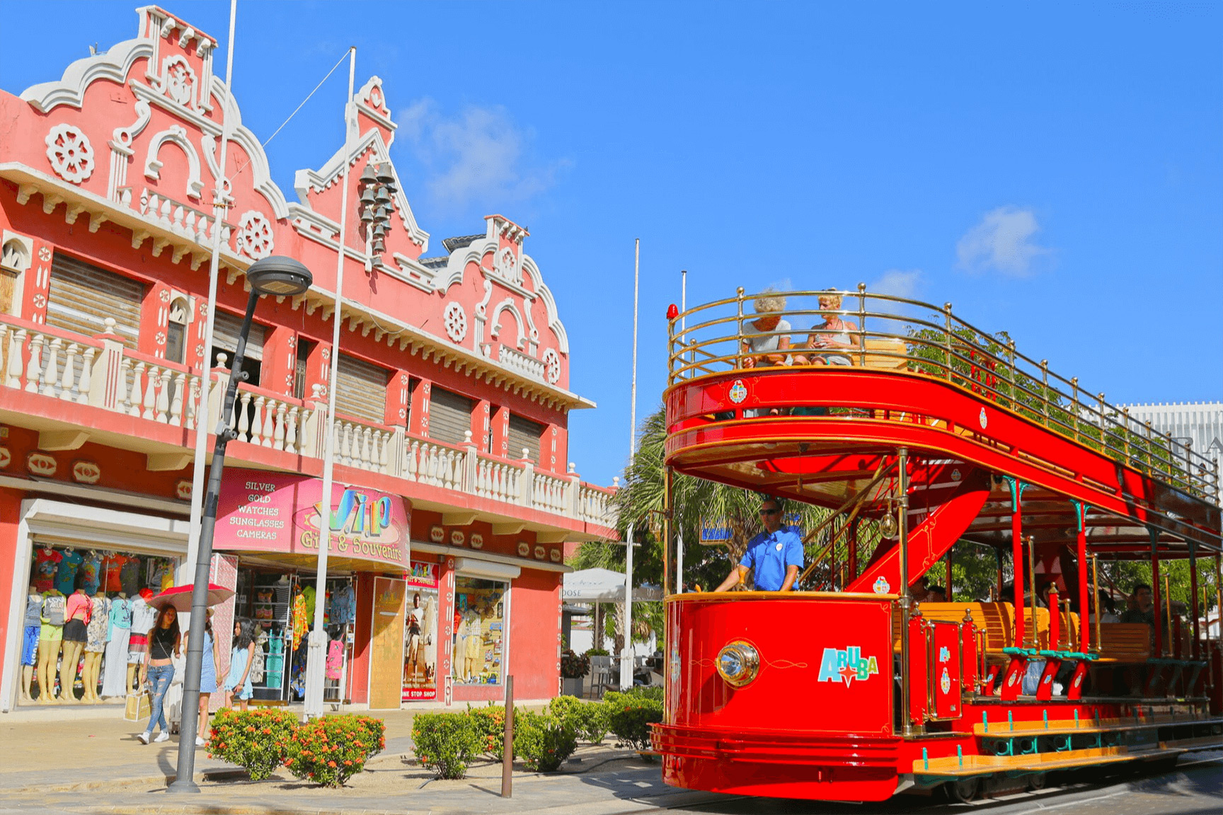 Oranjestad Streetcar passing colorful Dutch-Caribbean buildings in Aruba