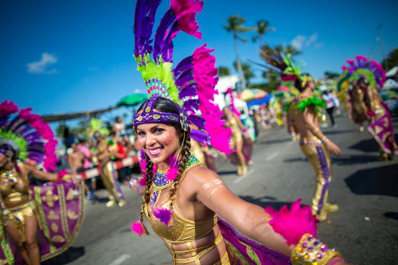 Colorful dancers celebrating Aruba Carnival with vibrant costumes and festive energy