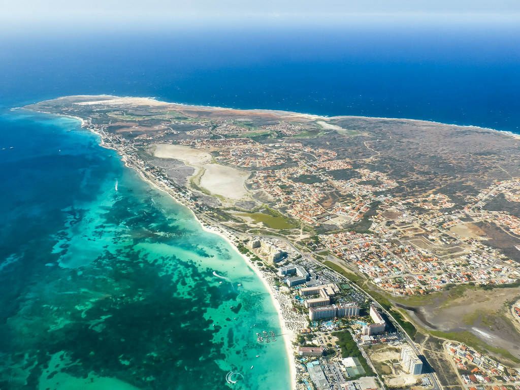 Aerial view of Aruba island with turquoise Caribbean waters, white-sand beaches and the dry inland landscape