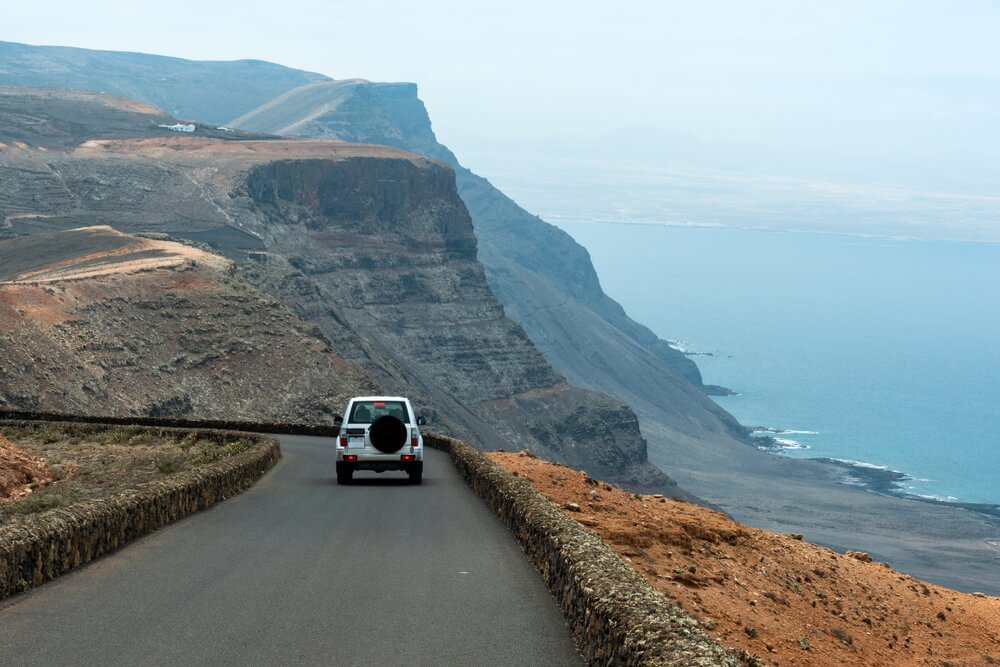 Scenic coastal road with rental car driving in the Canary Islands