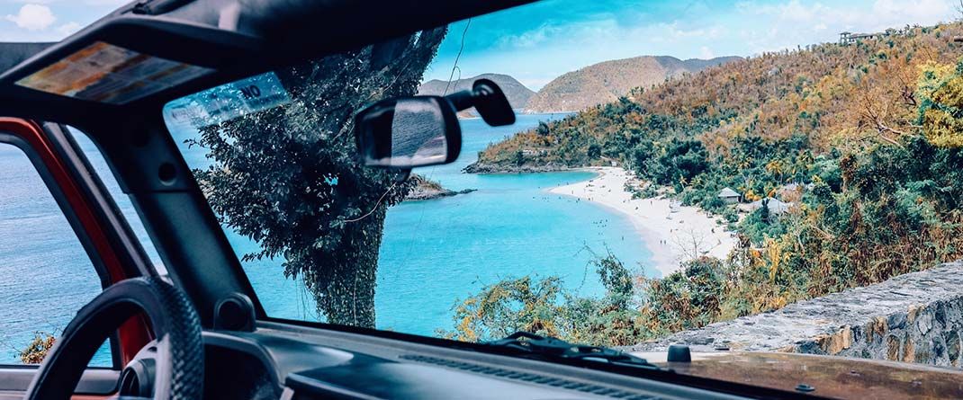 Driving a rental car along scenic coastal roads in the Virgin Islands