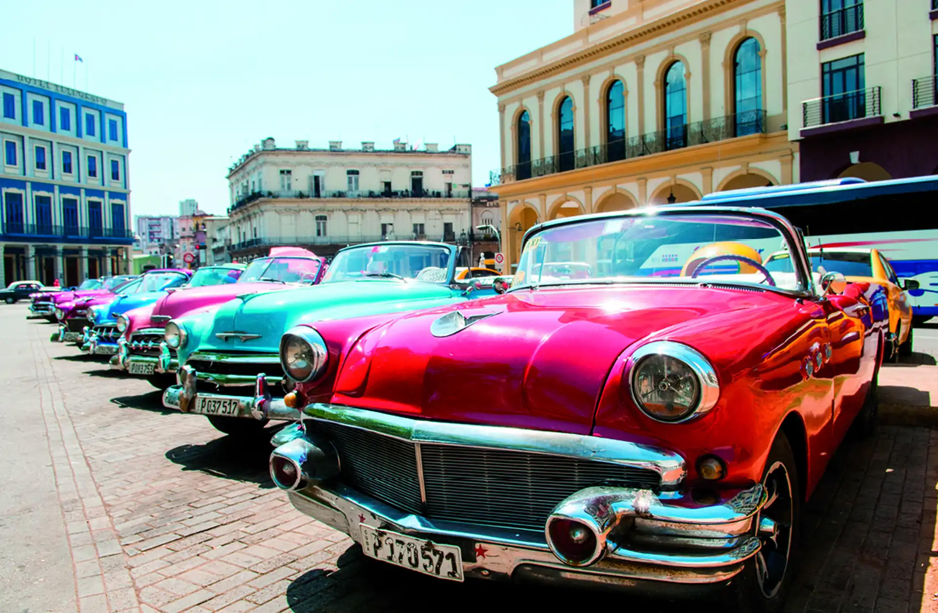 Colorful colonial buildings and classic cars on a street in Old Havana, Cuba