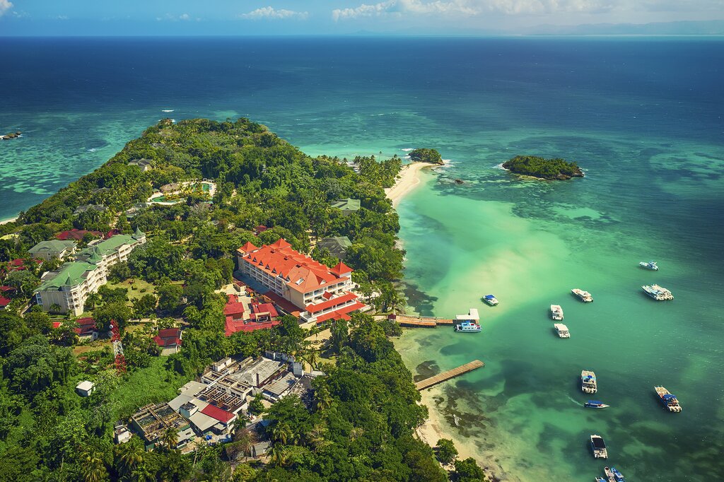Aerial view of a tropical coastal area in the Dominican Republic with turquoise water, small islands and beachfront resorts