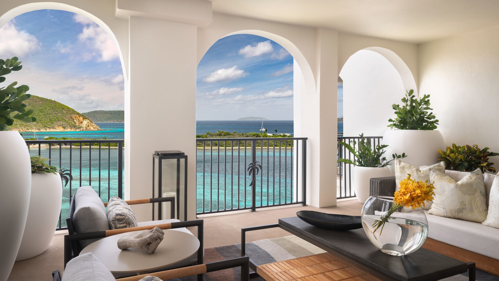 Oceanfront hotel terrace with seating area overlooking turquoise waters in the Virgin Islands