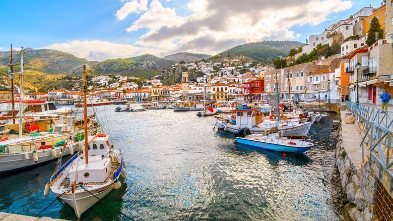 Romantic harbor in Hydra, Greece Hydra harbor with traditional stone houses and boats on the Greek island of Hydra