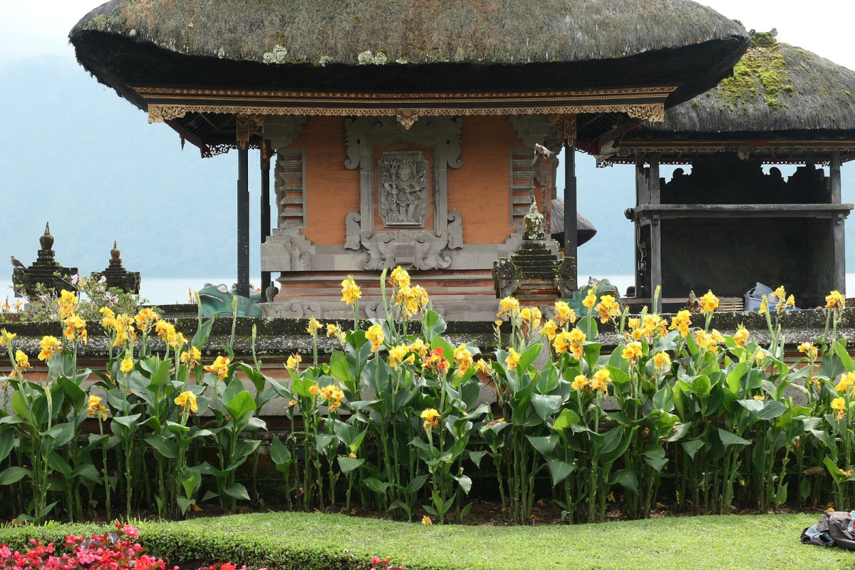 A temple pavilion and flowers in the Ulun Danu Beratan complex