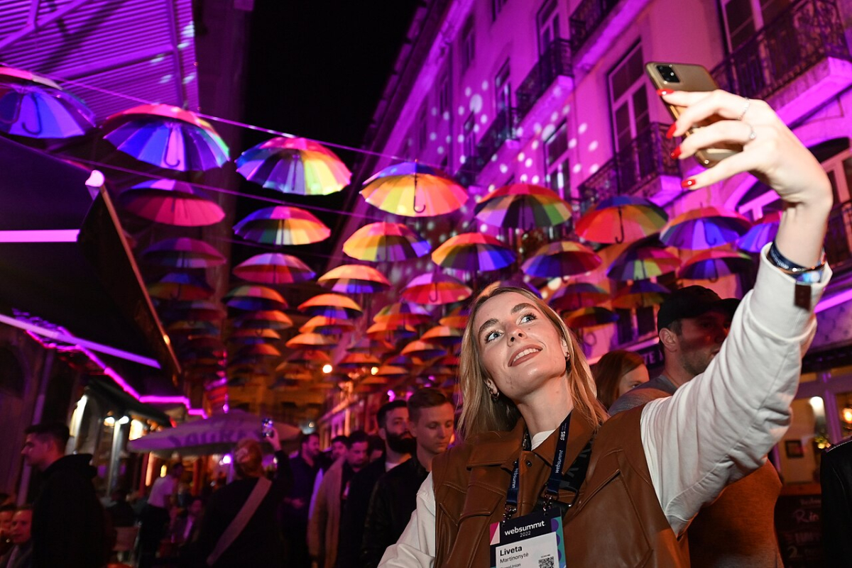 Pink Street during Night Summit 2022 Visitors beneath colourful umbrellas on Pink Street during Night Summit in Lisbon