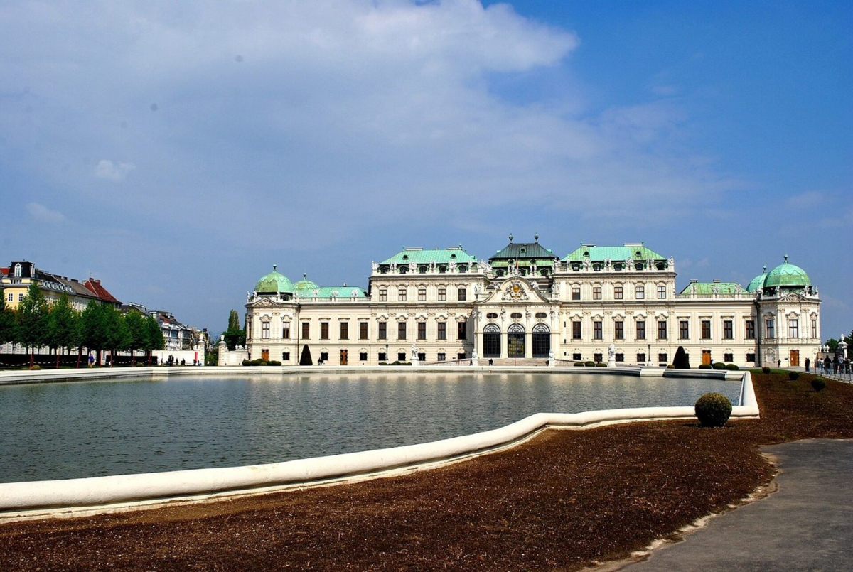 A Belvedere palace façade with water in the foreground A Belvedere palace façade with water in the foreground