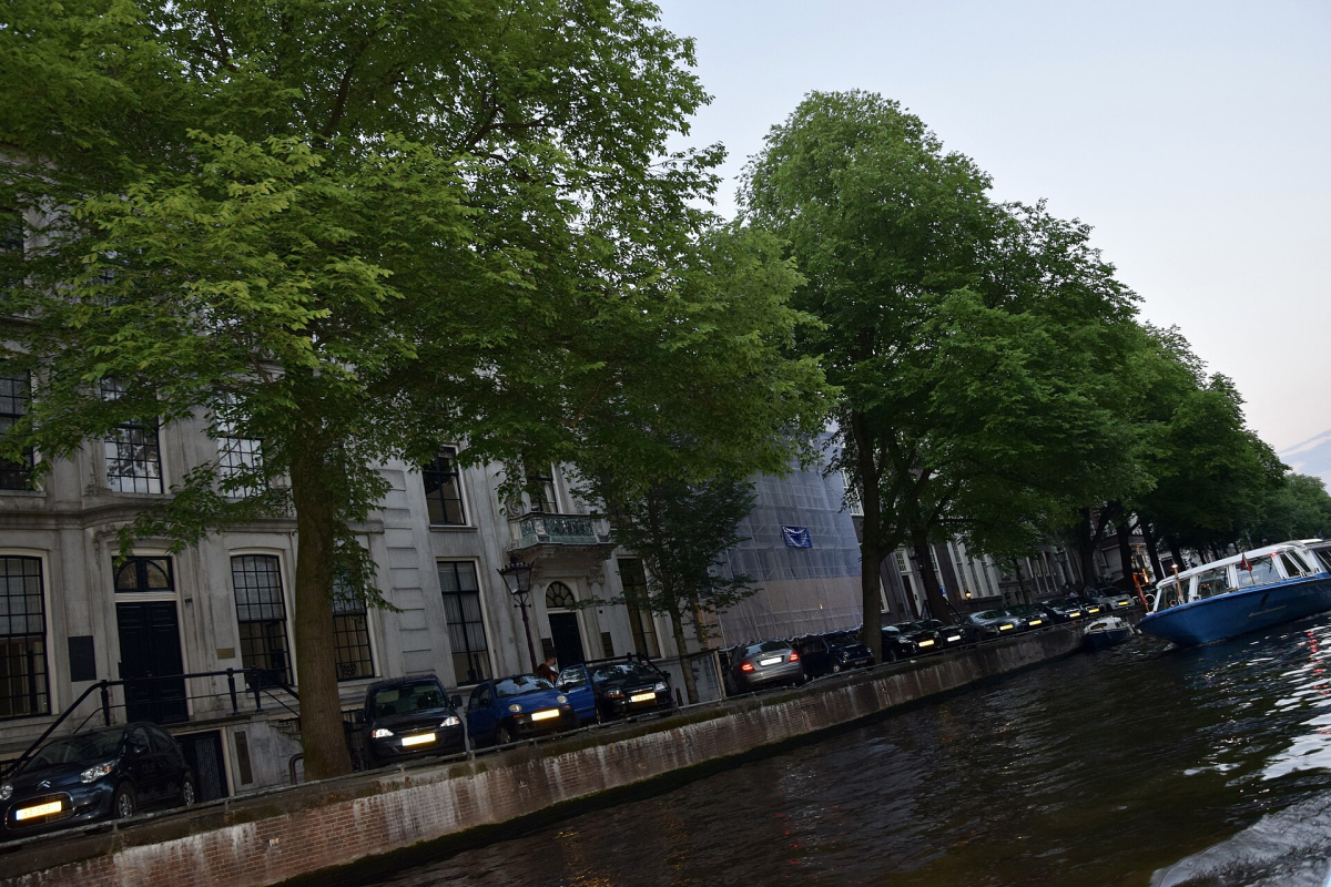 The rhythm of canal houses along the water.