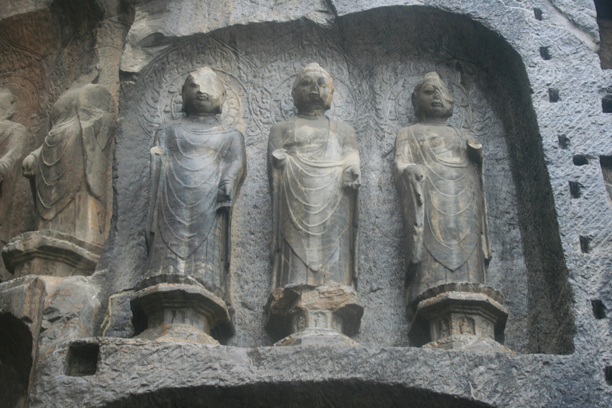 Carved Buddhist attendant figures at Longmen Grottoes Carved Buddhist attendant figures at Longmen Grottoes