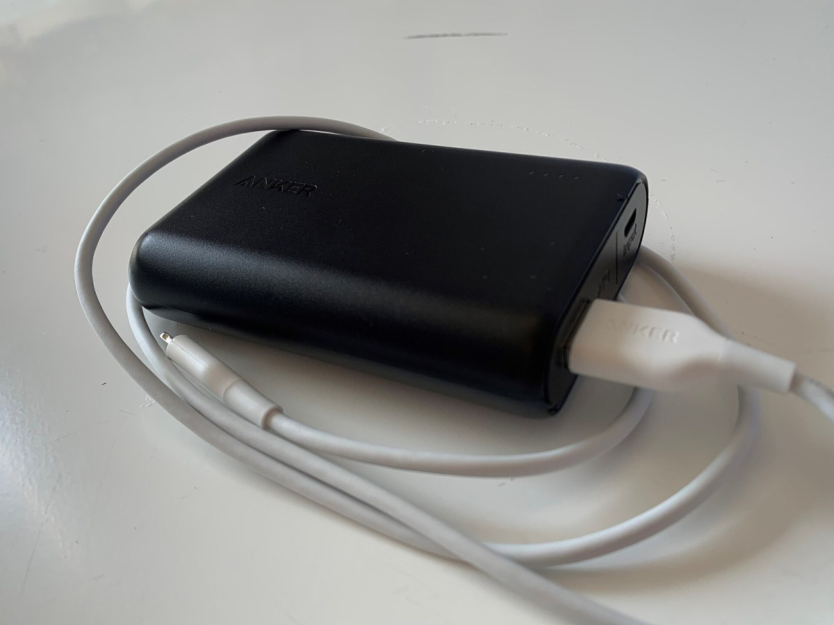 Portable power bank with an attached charging cable Portable power bank with an attached charging cable