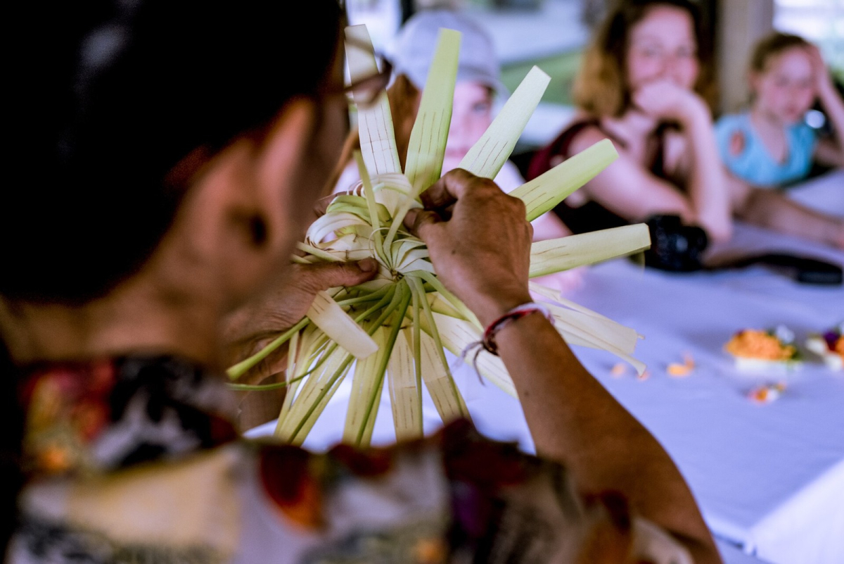 A Balinese woman demonstrating how to prepare canang offerings. A Balinese woman demonstrating how to prepare canang offerings