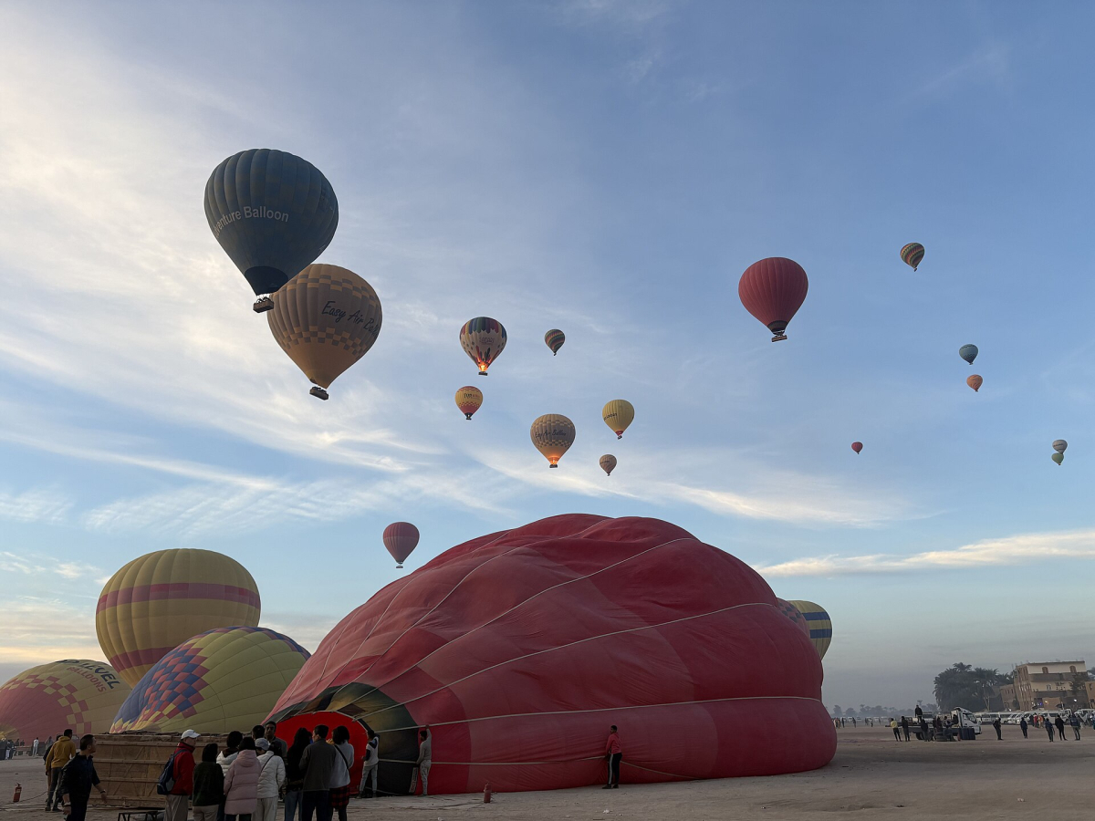 Hot air balloons preparing to launch near Luxor Hot air balloons preparing to launch near Luxor