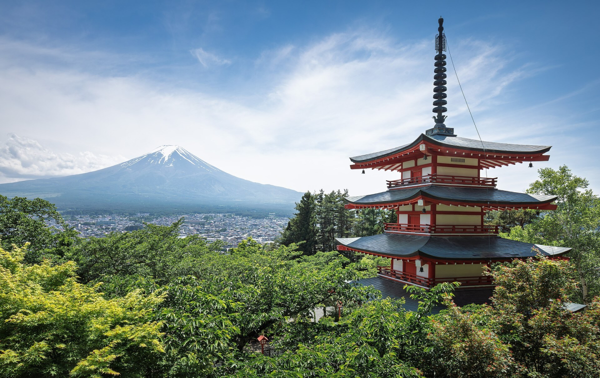 Chureito Pagoda and Mount Fuji above green trees in Fujiyoshida, Japan
