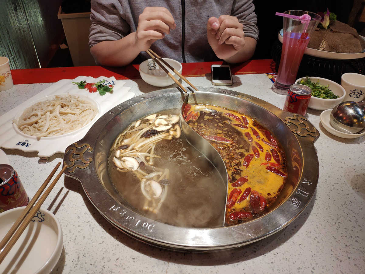 Sichuan-style hotpot with broth and ingredients Sichuan-style hotpot with broth and ingredients