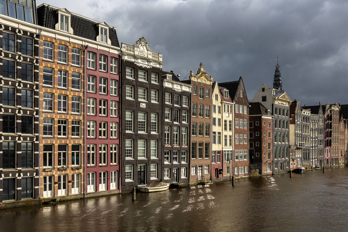 Canal houses at Damrak in warm light.
