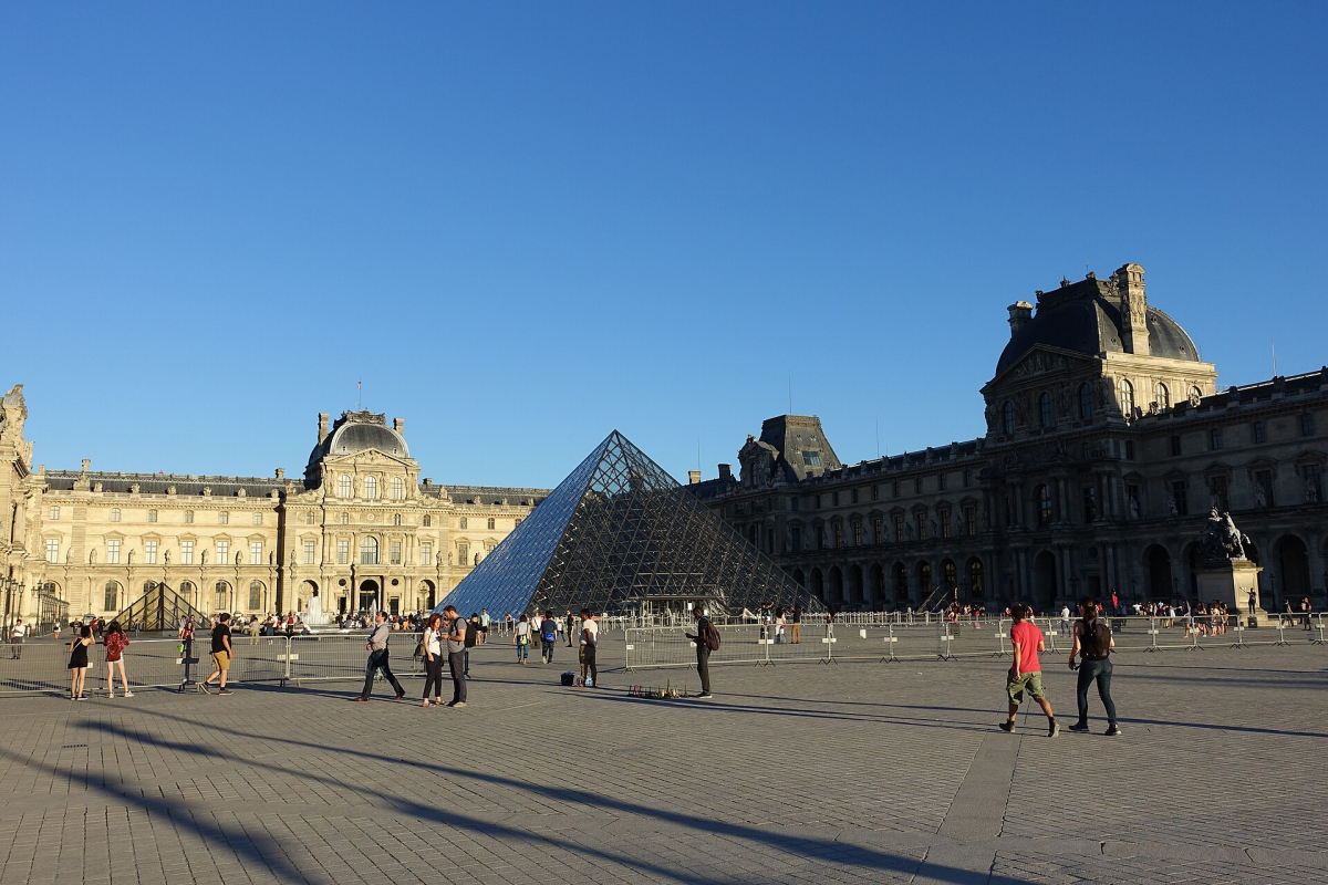 The Louvre courtyard; outdoor access and museum admission are different decisions.