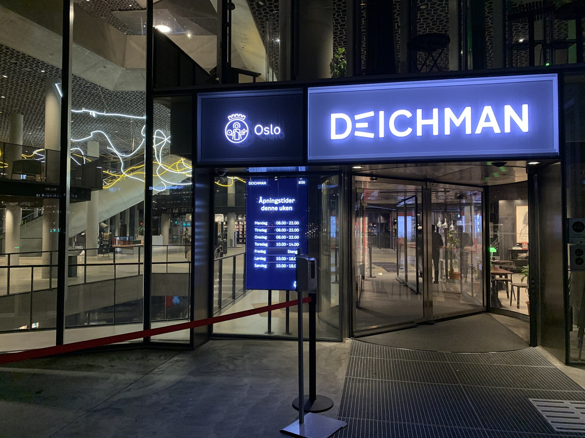The entrance to Deichman Bjørvika; opening times visible in the photograph are not a current timetable.