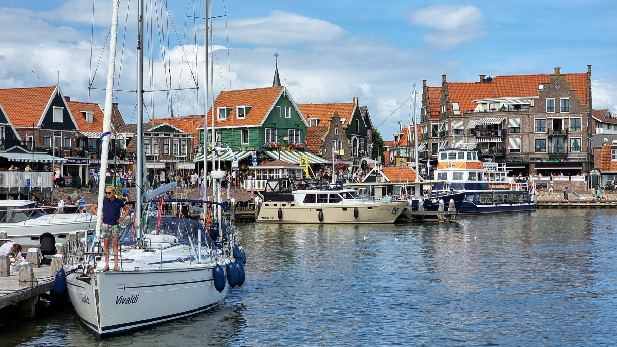 Boats and waterfront buildings in Volendam harbour. Boats and waterfront buildings in Volendam harbour.