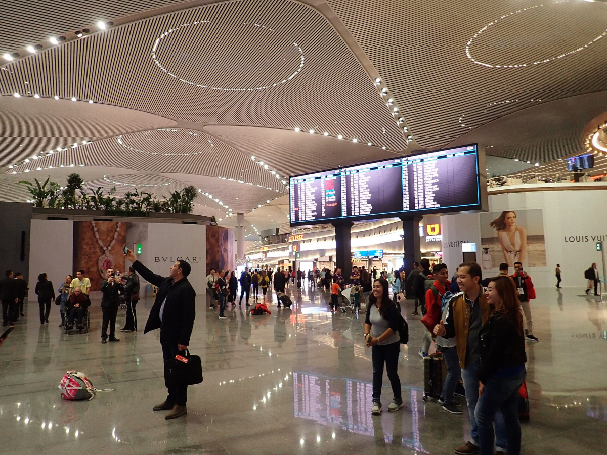 Passengers and flight information screens inside Istanbul Airport Passengers and flight information screens inside Istanbul Airport
