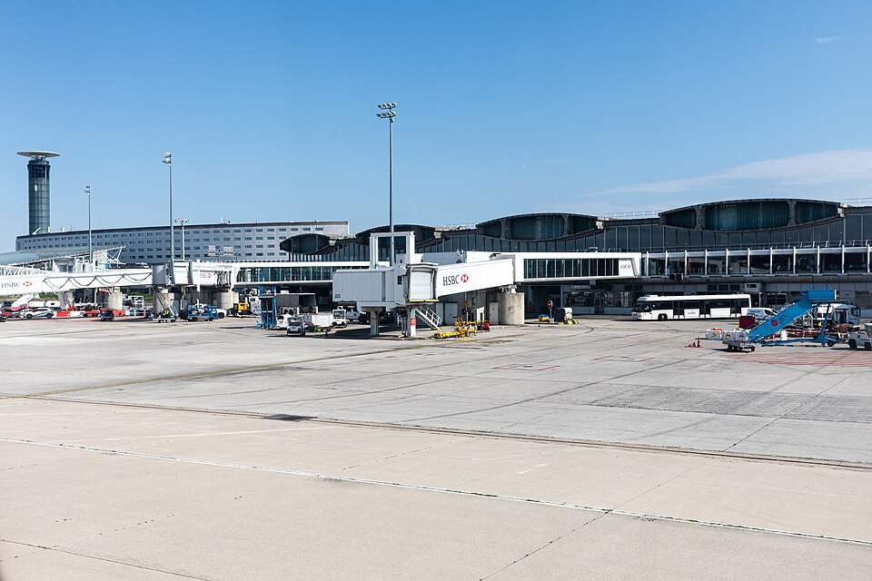 Terminal buildings and a jet bridge at Paris Charles de Gaulle Airport; border controls are inside the terminal.