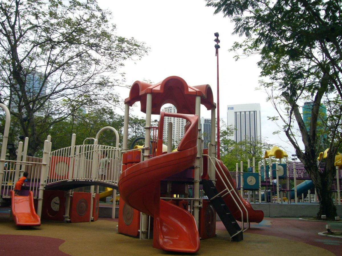 Play equipment in KLCC Park. Confirm current facility access and supervise children.