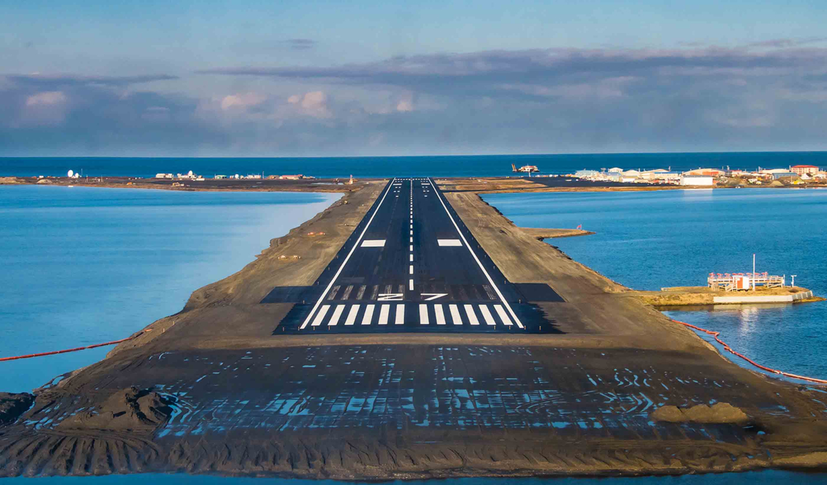 Aircraft landing on a runway next to the ocean at Lanzarote Airport