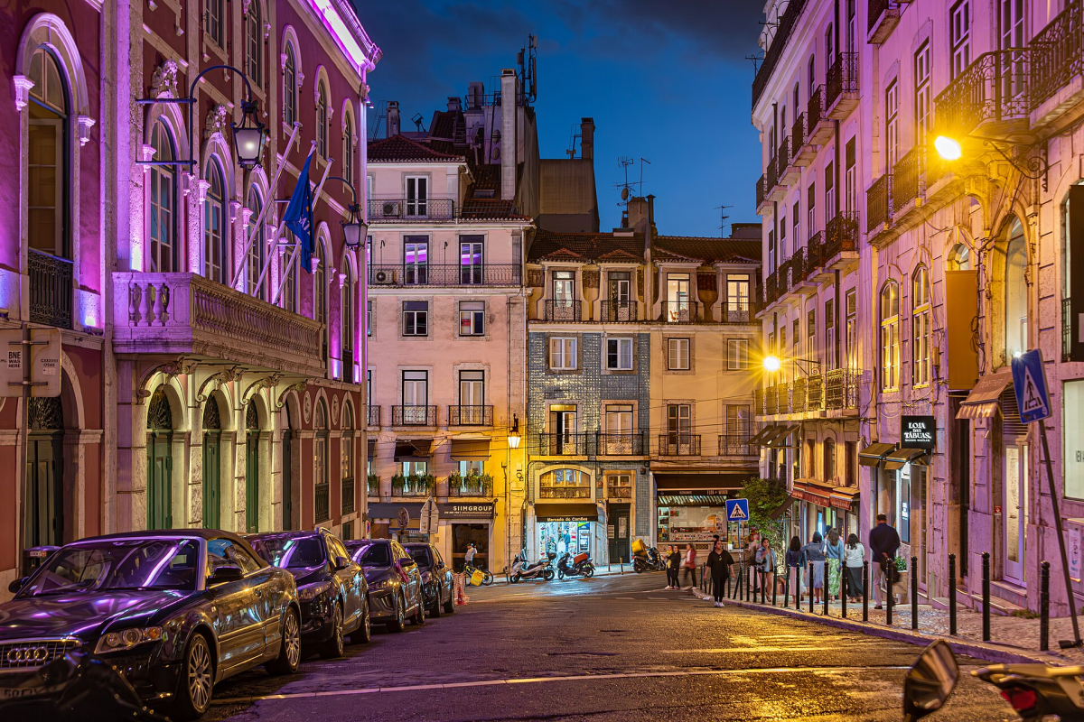 Illuminated historic façades and tram in Bairro Alto, Lisbon