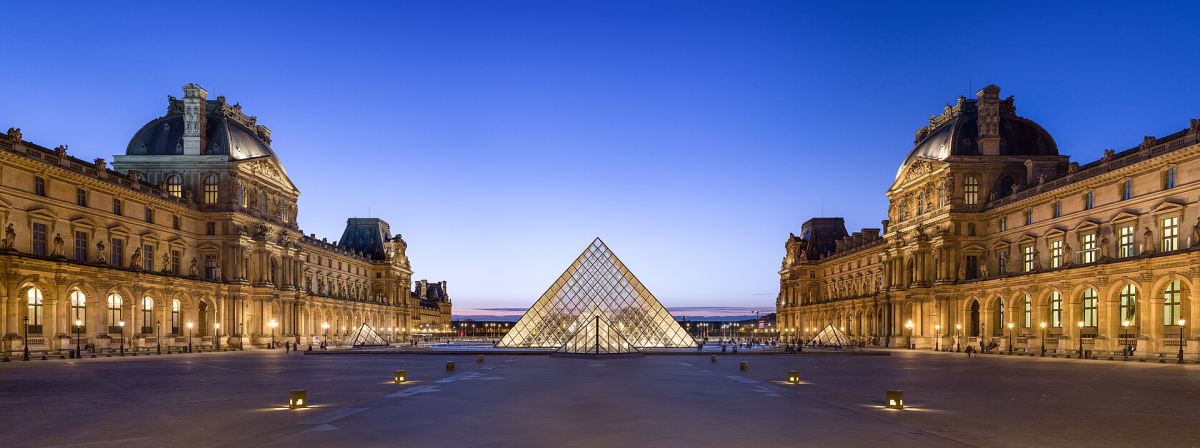 The Louvre courtyard and Pyramid at dusk.