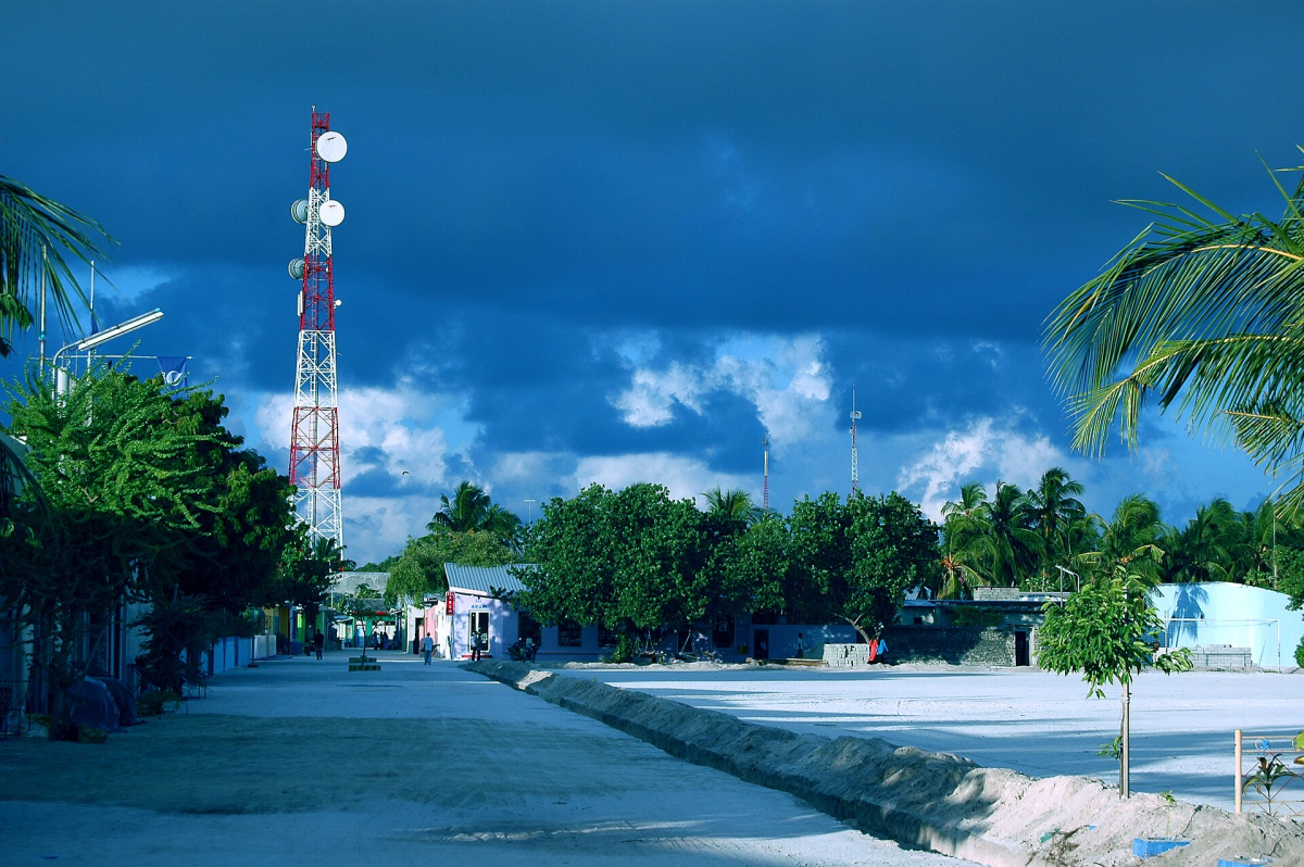 Main street with palms and trees in Maafushi Main street with palms and trees in Maafushi