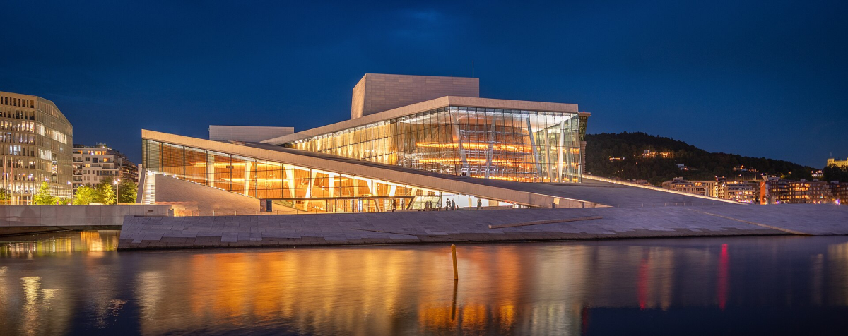 The Opera House illuminated beside the water in August 2025, illustrating the contrast between warm interior light and the evening sky. The Opera House illuminated beside the water in August 2025, illustrating the contrast between warm interior light and the evening sky.