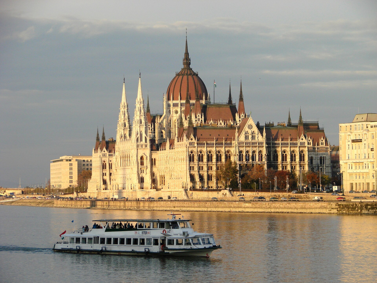 Sightseeing boat and Parliament on the Danube in Budapest Sightseeing boat and Parliament on the Danube in Budapest