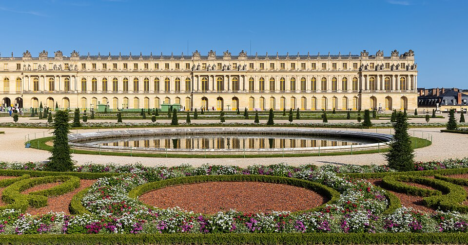 The Palace of Versailles and Parterre du Midi garden at golden hour. The Palace of Versailles and Parterre du Midi garden at golden hour.