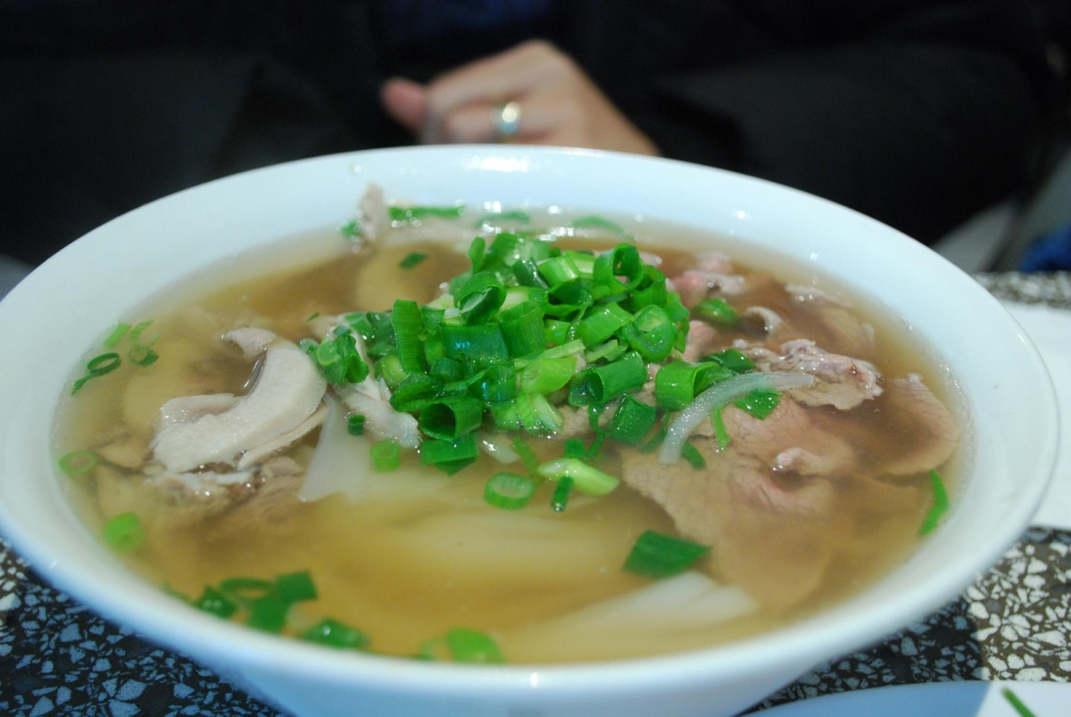 Bowl of pho with noodles, meat and herbs, photographed in Melbourne as an illustration of the Vietnamese dish