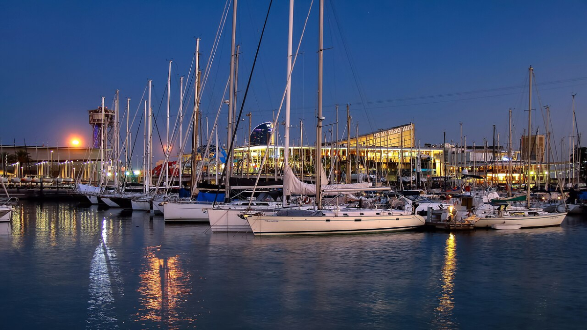 Sailing boats moored at Port Vell in Barcelona at dusk