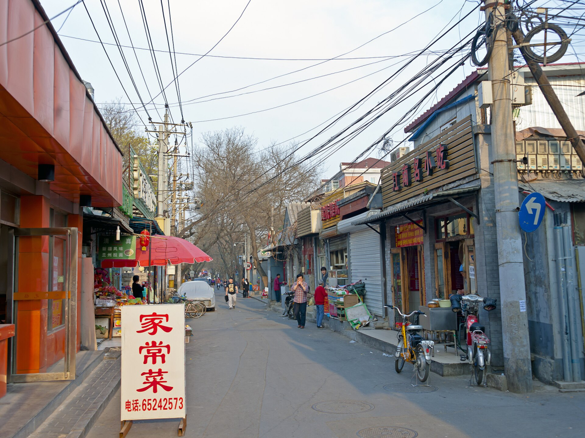 A Beijing lane with local signs and street activity A Beijing lane with local signs and street activity