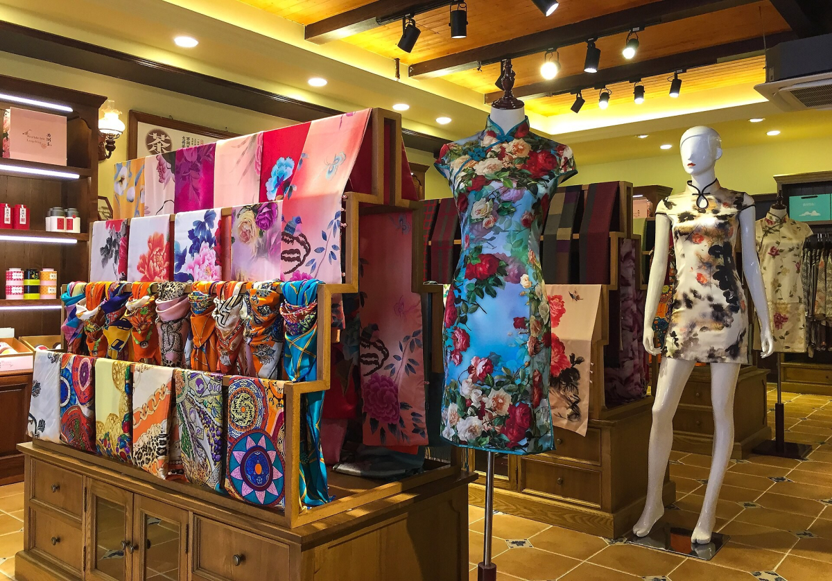 Colourful scarves and qipao displayed in a Hangzhou textile shop