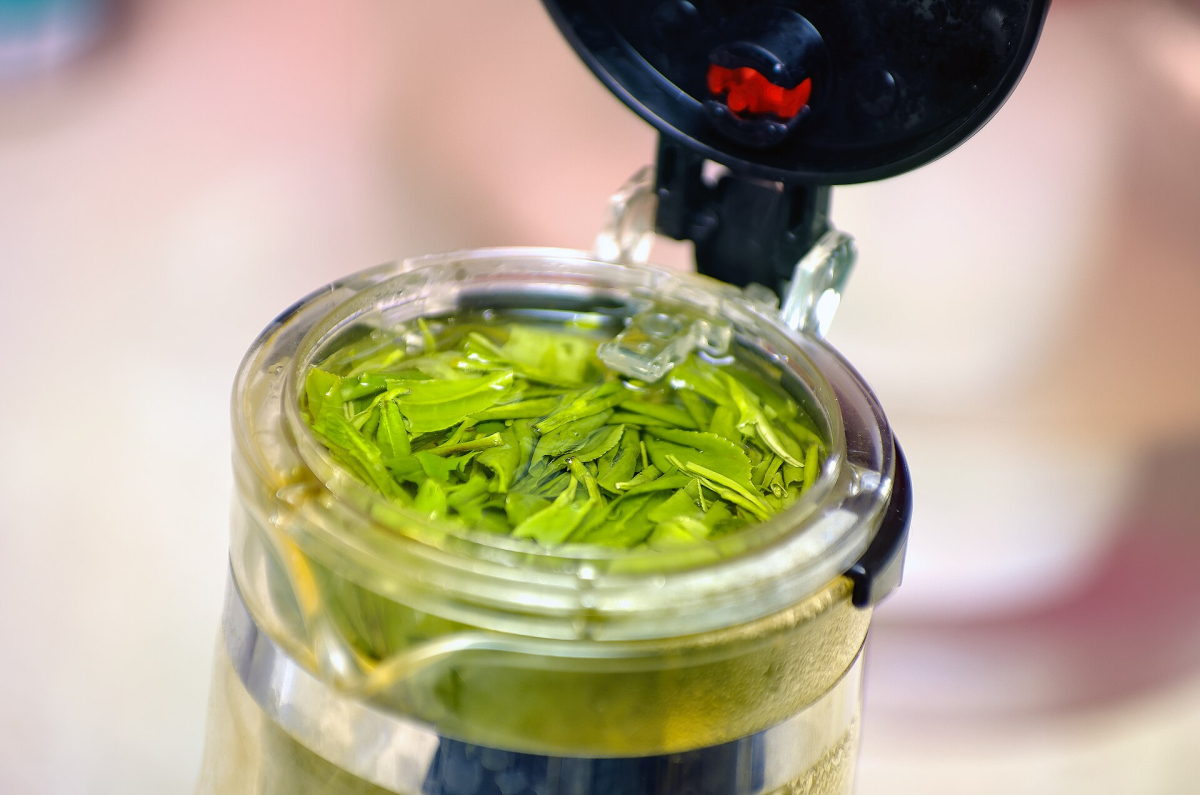 Chinese green tea leaves and a prepared serving Chinese green tea leaves and a prepared serving