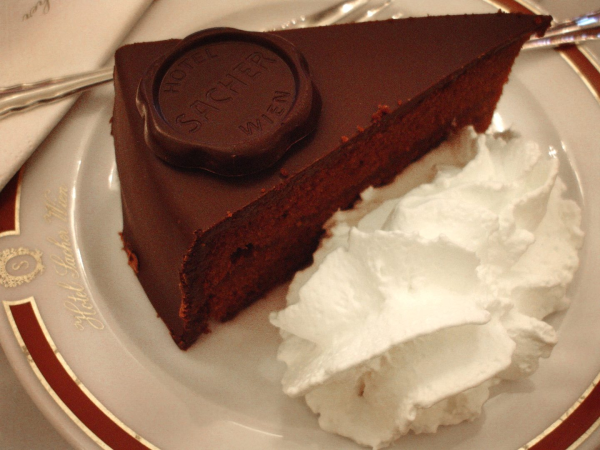 A slice of Sachertorte with cream A slice of Sachertorte with cream