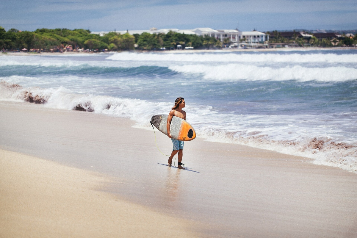 A surfer at Kuta Beach. A surfer at Kuta Beach