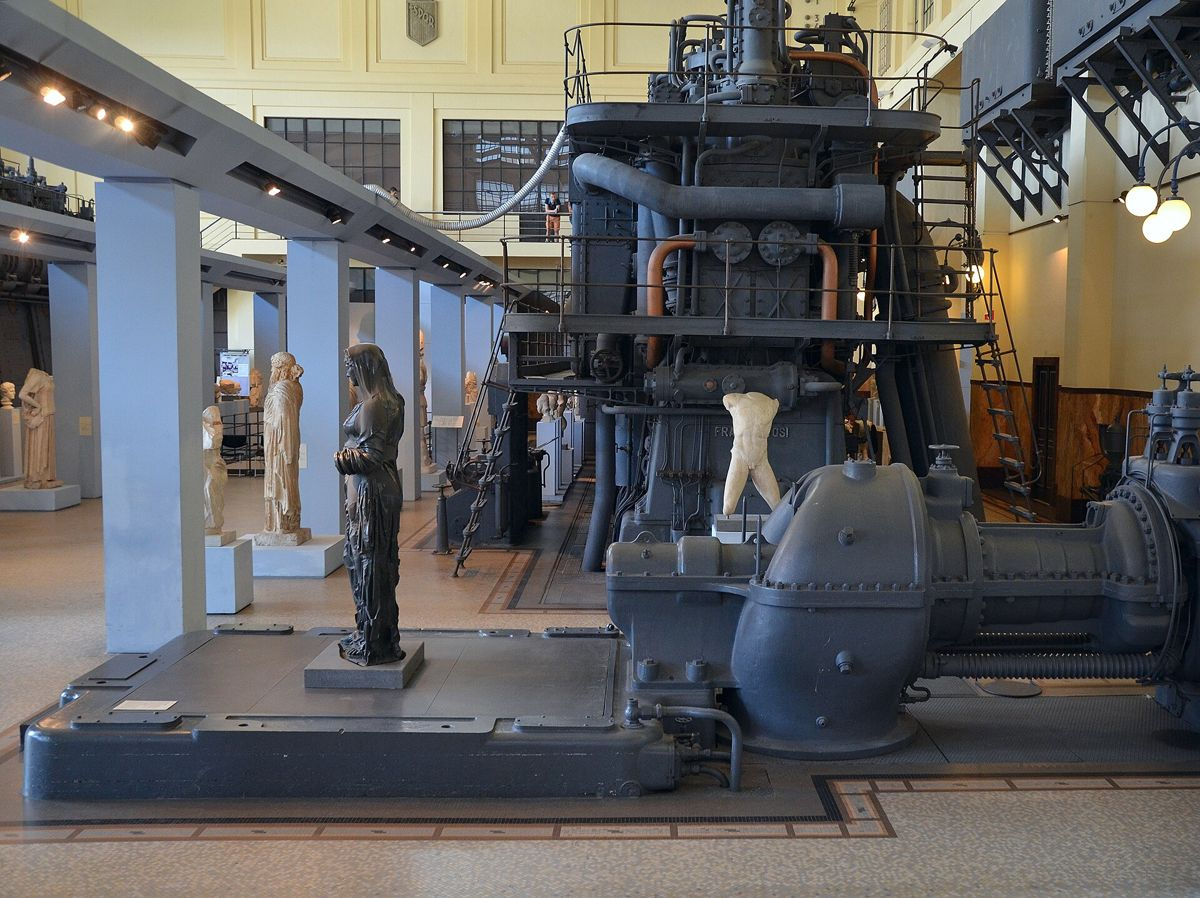 Ancient sculpture and industrial machinery in the Engine Room at Centrale Montemartini