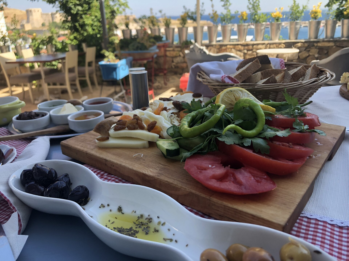 A Turkish breakfast spread with cheese, olives, bread and vegetables