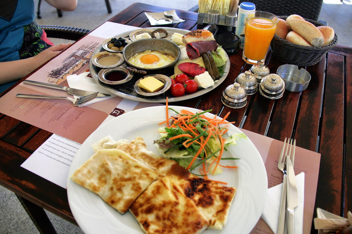 Turkish breakfast with eggs, cheese, olives, tomatoes and bread