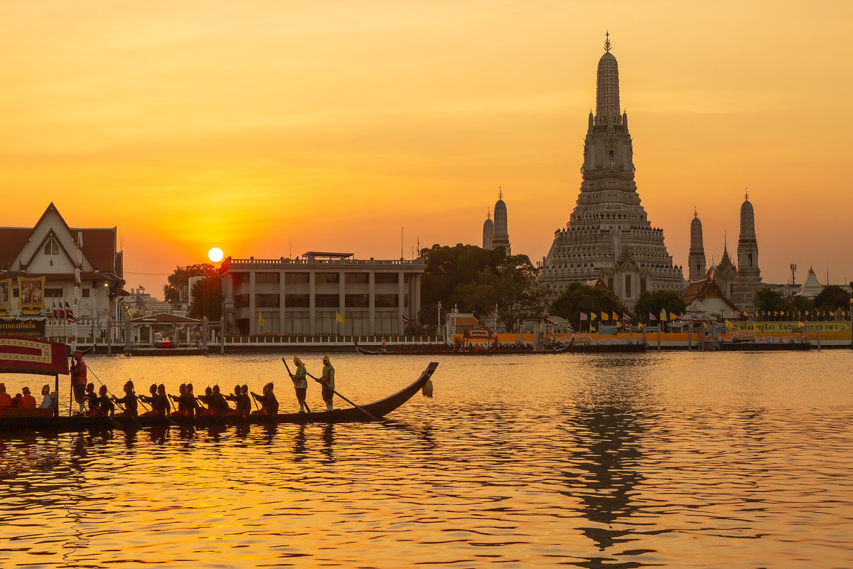 Wat Arun during a royal barge procession. Historical event photograph; no future procession or access is implied. Wat Arun during a royal barge procession