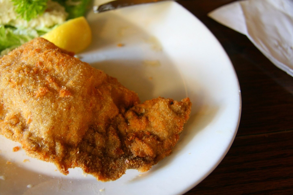 A Wiener Schnitzel served on a plate A Wiener Schnitzel served on a plate