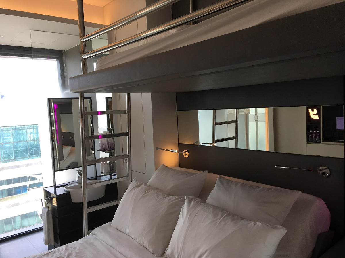 Room interior at YOTEL Singapore with a bed and upper bunk